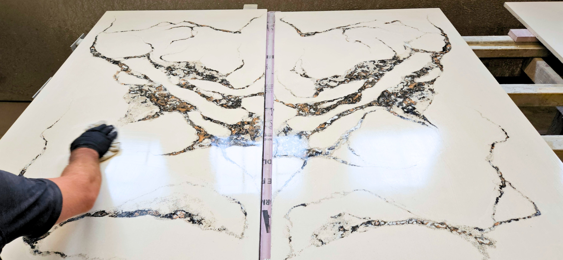 Two-panel cross-section of quartz countertop showing crystalline structure and mineral composition with measurement scale, person's gloved hand pointing to detail