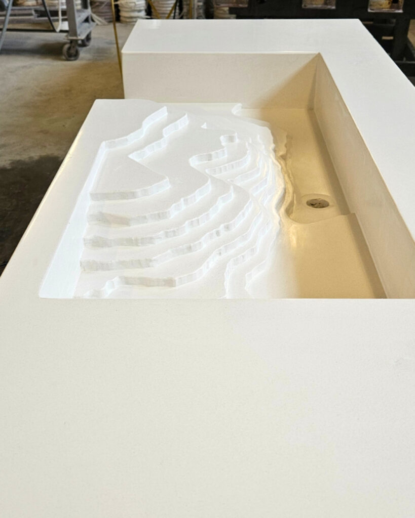 White architectural model of curved seating or stadium bleachers in a display box at a Cincinnati design or marketing firm