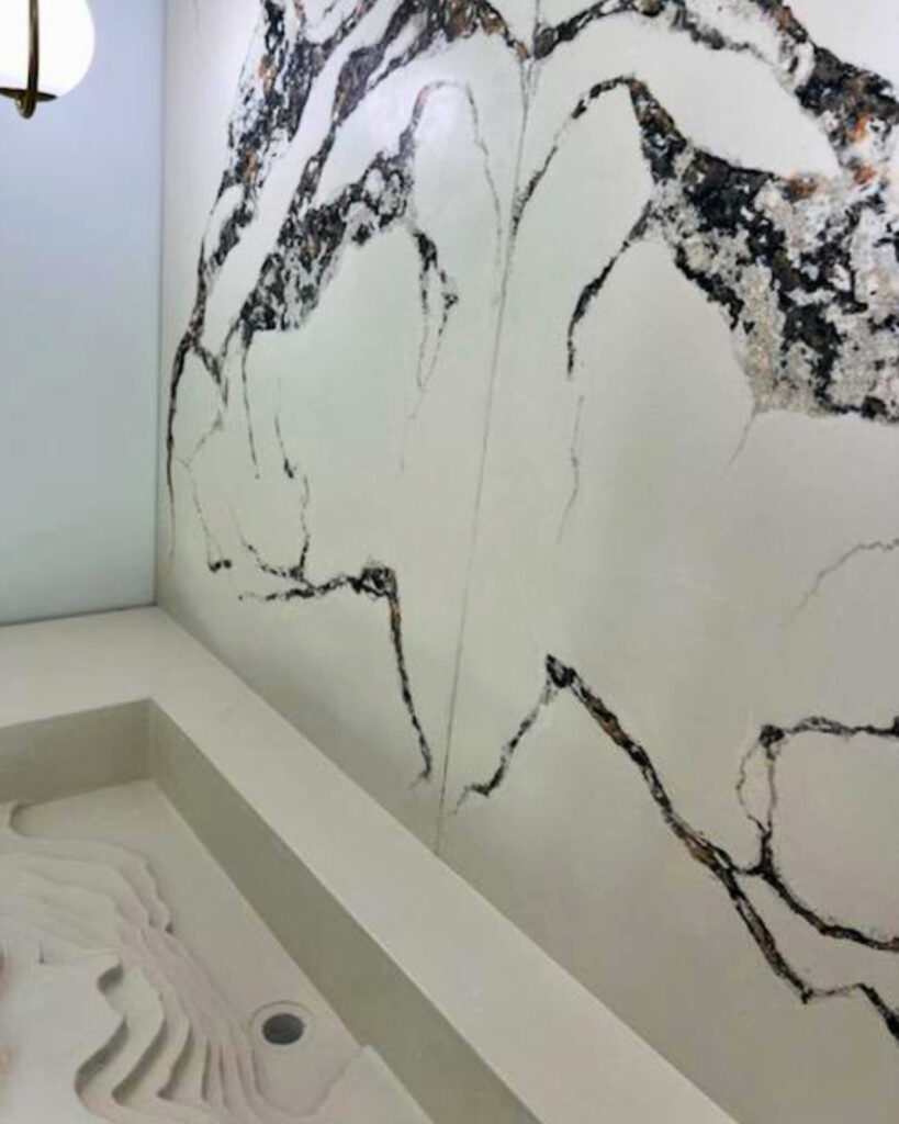 Bathroom wall with extensive black mold growth and water damage stains on white tile above a sink