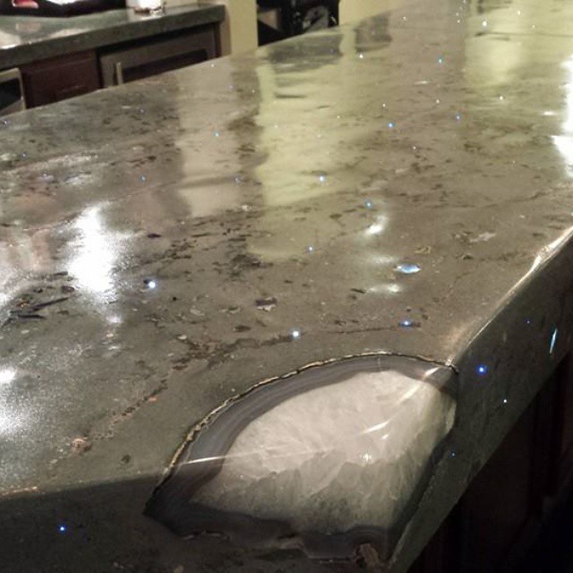 Wet concrete countertop with decorative blue sparkle aggregate and custom-shaped edge detail